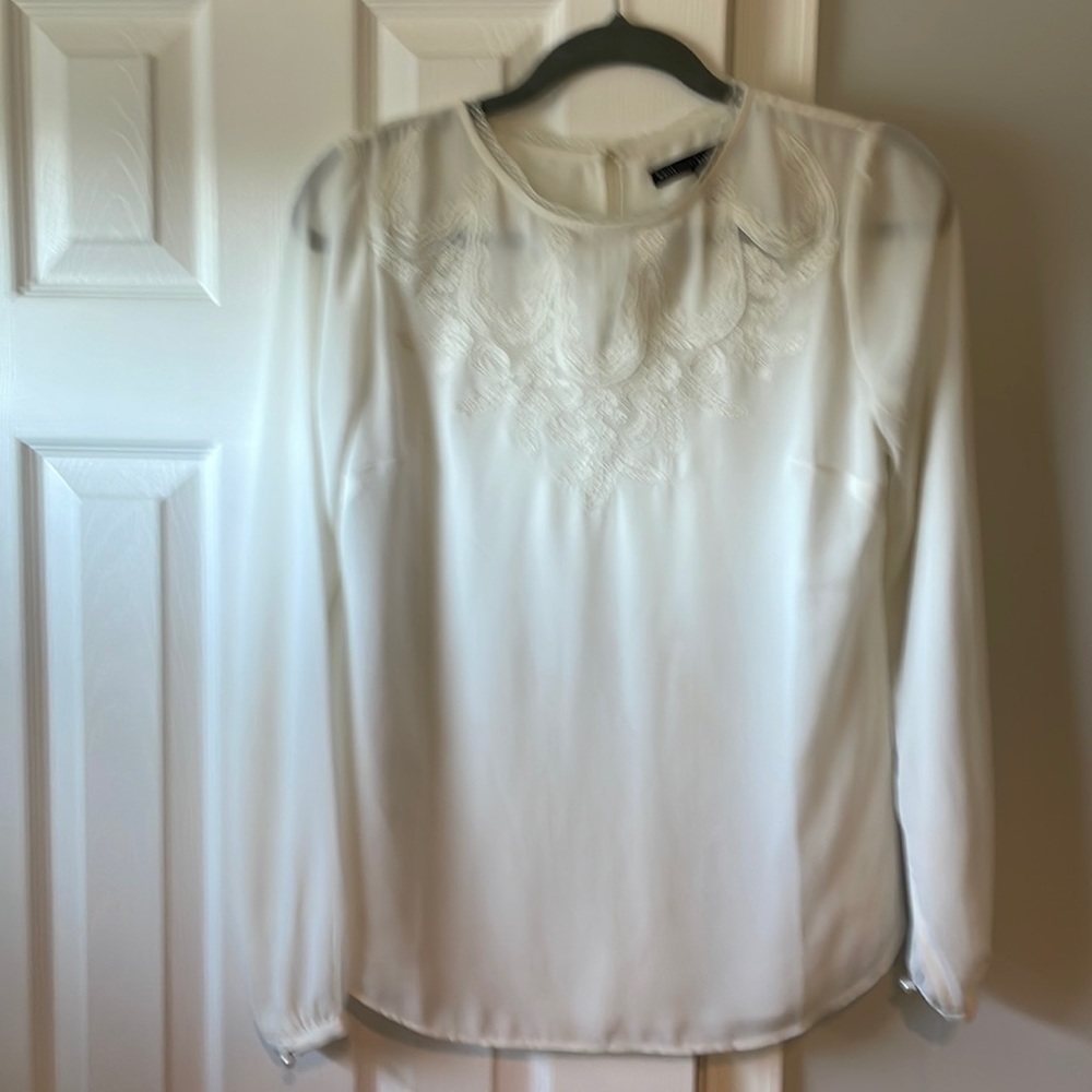 Cream blouse with lace design around neck